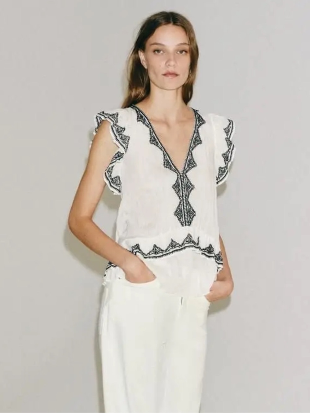 Zara - embroidered V-neck top with black trim and ruffle sleeves
